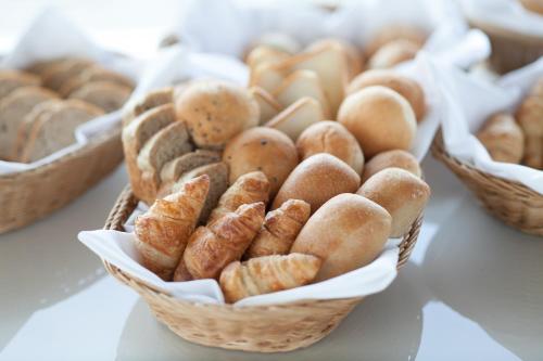 a bunch of baskets of pastries on a table at KKR Hotel Osaka in Osaka