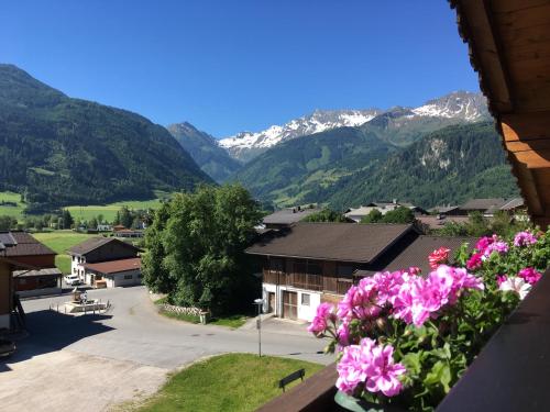 a view from a balcony of a village with mountains at Haus Höllerer in Uttendorf