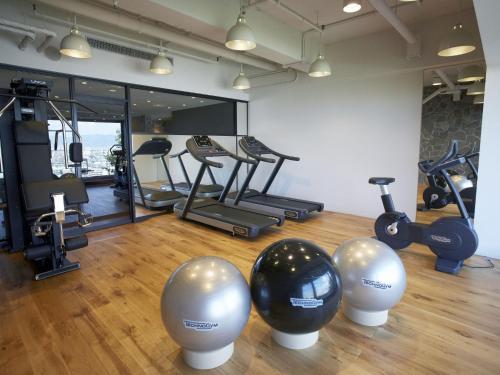 a gym with exercise balls and exercise bikes at Hilltop Resort Fukuoka in Fukuoka