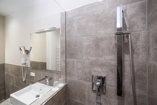 a bathroom with a shower and a sink at Hotel Angerbräu in Murnau am Staffelsee