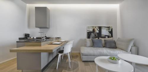 a kitchen and a living room with a couch at Luxury Suites Collection - Milano 33 in Riccione