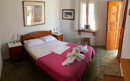 a bedroom with a bed with a towel on it at Antheia in Chora Folegandros