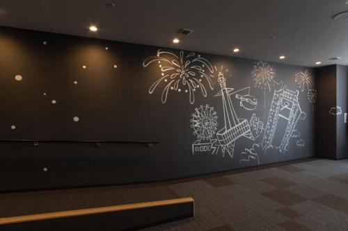 a wall mural in a room with fireworks at Izumisano Center Hotel Kansai International Airport in Izumi-Sano