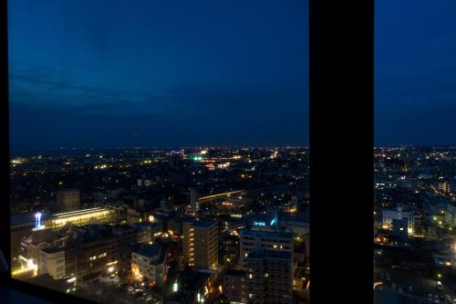 a view of a city at night with lights at Izumisano Center Hotel Kansai International Airport in Izumi-Sano