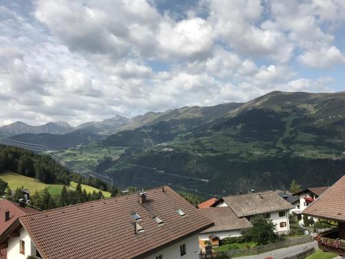 a view of a village with mountains in the background at Pension Burgschroffen in Fendels