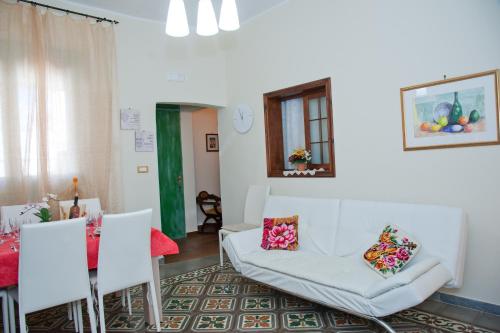 a living room with a white couch and chairs at La Casa di Baldo in Ugento