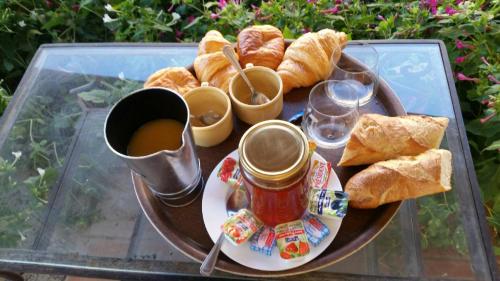 a tray of bread and coffee on a glass table at Domaine du Serre d'Avène in Saint-Christol-lès-Alès