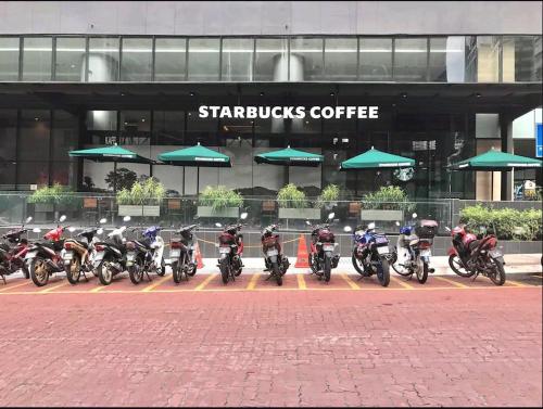 a group of motorcycles parked in front of a building at VORTEX SUITES KLCC by PNUT With NETFLIX in Kuala Lumpur