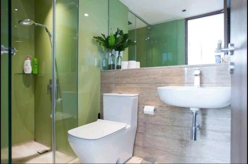 a bathroom with a toilet and a sink and a shower at VORTEX SUITES KLCC by PNUT With NETFLIX in Kuala Lumpur