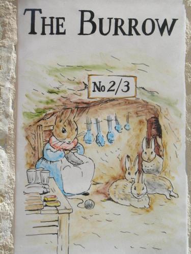 a book with a picture of two rabbits in a kitchen at The Burrow Guest House in Tarxien