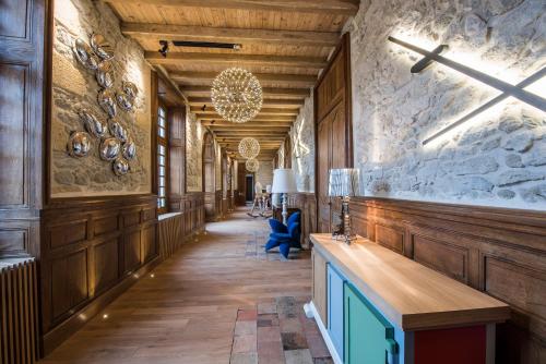 a hallway in a building with wooden walls at Chateau Prieure Marquet in Saint-Martin-du-Bois