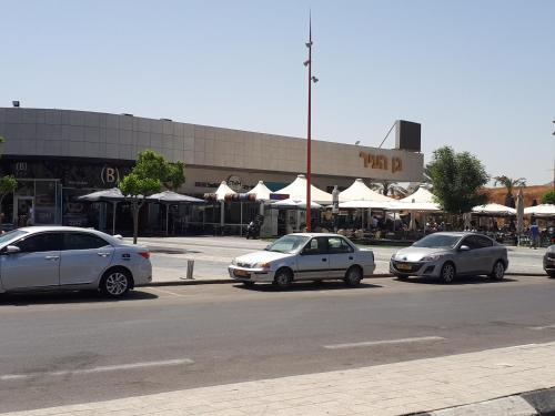 three cars parked in a parking lot in front of a building at Apartment 2 bedrooms Central Location in Ashdod