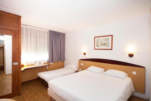 Säng eller sängar i ett rum på Campanile Barcelona