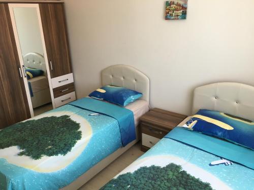 - une chambre avec 2 lits et un miroir dans l'établissement Fursan Apart, à Trabzon