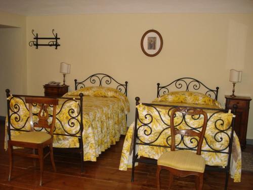 a bedroom with two beds and a table and chairs at Santuario di Oropa in Biella