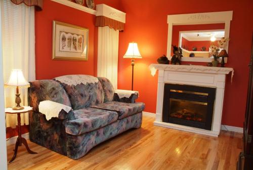 a living room with a couch and a fireplace at Côté's Bed & Breakfast in Grand Falls
