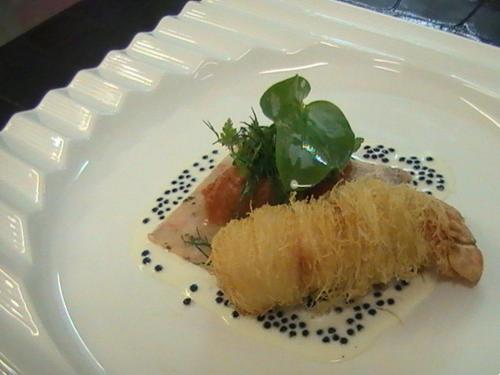a white plate with a piece of food on it at Logis Hotel Restaurant Au Boeuf Rouge in Niederschaeffolsheim