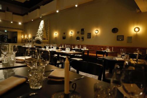 a restaurant with tables and chairs and a christmas tree at Original Sokos Hotel Vaakuna Mikkeli in Mikkeli