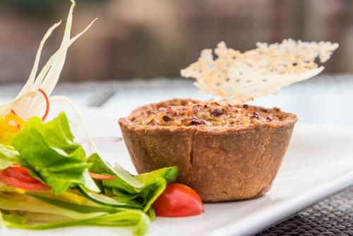 a plate of food with a sandwich and a salad at Executive Residency by Best Western Nairobi in Nairobi