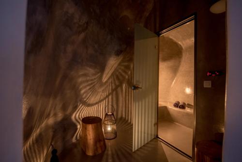 a bathroom with a wall mural of a woman at Amorous Villa-By Senses Collection in Pirgos