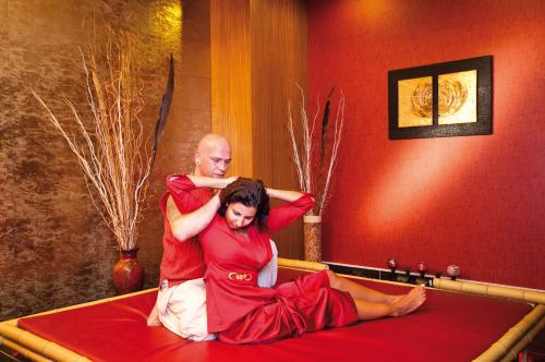a man and a woman sitting on a bed at Royal Holiday Palace in Lara