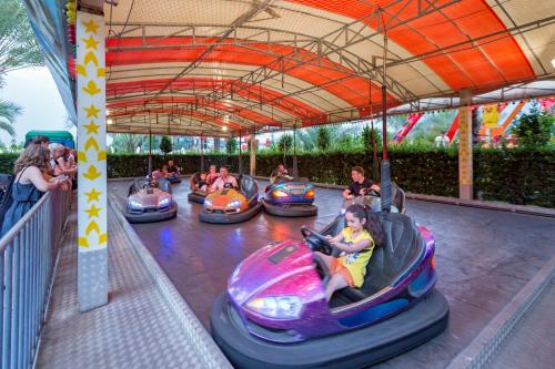 a group of people riding on bumper cars at an amusement park at Royal Holiday Palace in Lara