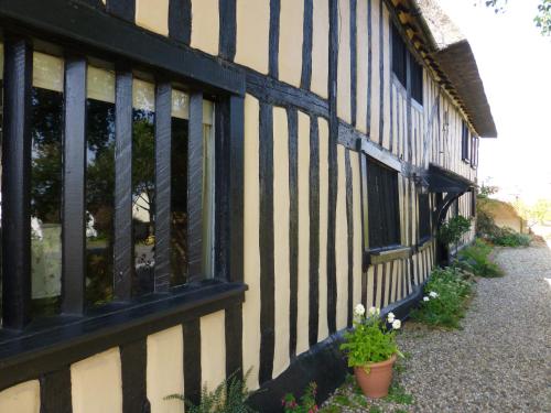 a black and white building with windows and plants at The Greyhound - Historic former Inn in Glemsford