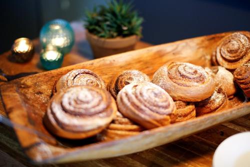 a wooden plate of pastries on a table at Unstad Arctic Resort in Unstad