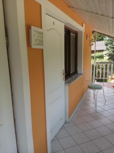 a door to a balcony with a chair and a window at Pension Jana Tatrovice in Tatrovice