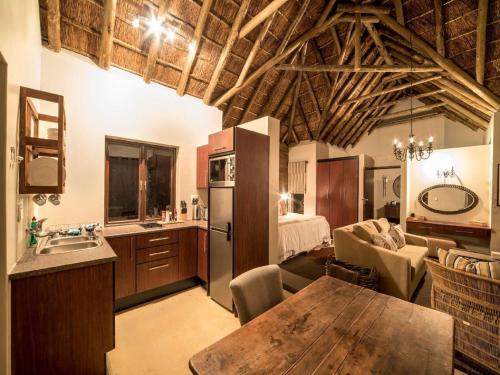 a kitchen with a table and a room with a bed at Burlington Bush Cottages by The Oyster Collection in Salem