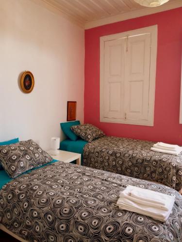 a room with two beds and a white door at Casa de Encosturas in Cabeceiras de Basto