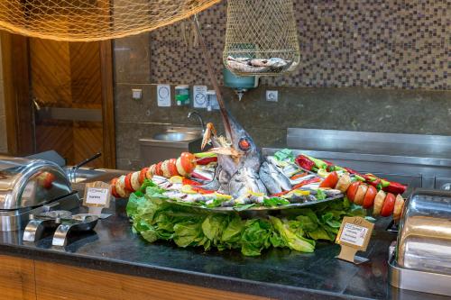 a display of food on a counter in a kitchen at Royal Holiday Palace in Lara