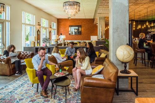 a group of people sitting in chairs in a lobby at Mercure Paris Porte de Pantin in Pantin