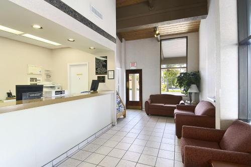 a lobby of a hospital with couches and a waiting room at Super 8 by Wyndham Riviera Beach West Palm Beach in Riviera Beach