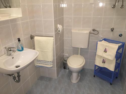 a bathroom with a toilet and a sink at Apartman Mimoz in Senj