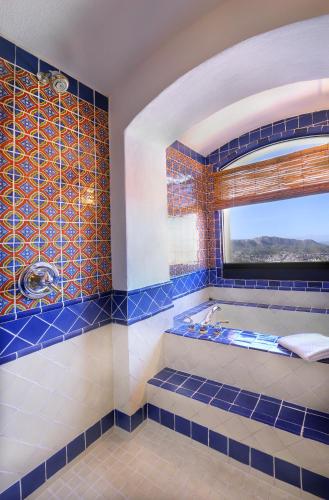 a blue tiled bathroom with a tub and a window at Casa Estrella de la Valenciana Hotel Boutique in Guanajuato