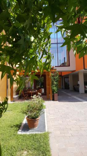 a building with some plants in front of it at UNAHOTELS Eco Hotel Villa Costanza Venezia in Mestre