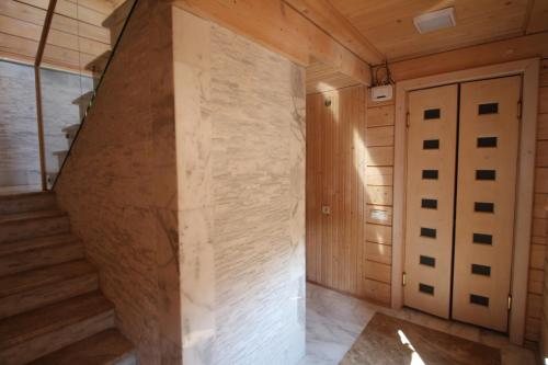 a staircase in a room with wooden walls at Villa Kaiser in Lviv