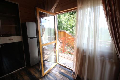 a sliding glass door with a view of a yard at Villa Kaiser in Lviv