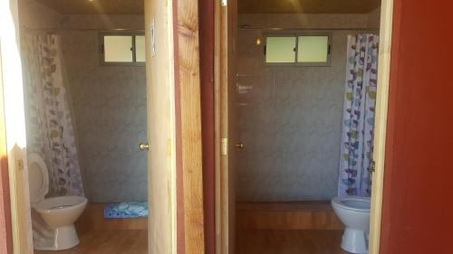 a bathroom with a toilet and a sink at Hostal Mirador in San Pedro de Atacama