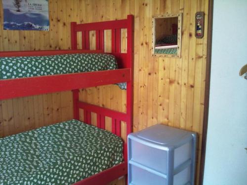 a bedroom with two bunk beds and a trash can at Isa in La Thuile