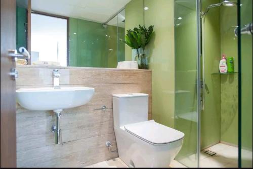 a bathroom with a sink and a toilet and a shower at VORTEX SUITES KLCC by PNUT With NETFLIX in Kuala Lumpur