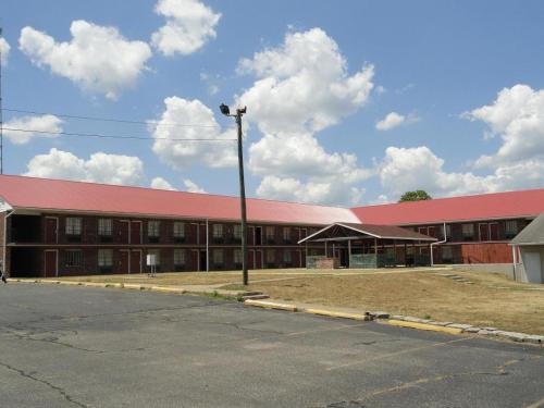 a large red building with a red roof at Red Carpet Inn (formerly Royal Inn) in Terre Haute