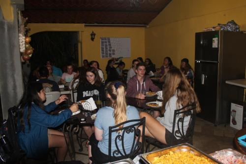 a group of people sitting at tables in a room at Hotel Santa Maria Inn in Alajuela City