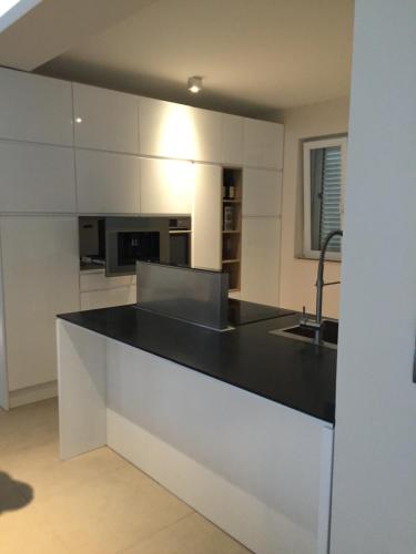 a kitchen with a black and white counter top at Villa Dea in Kotor