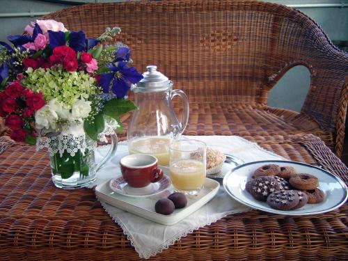 a table with a tray of breakfast foods and a vase of flowers at La Cascata in Noci