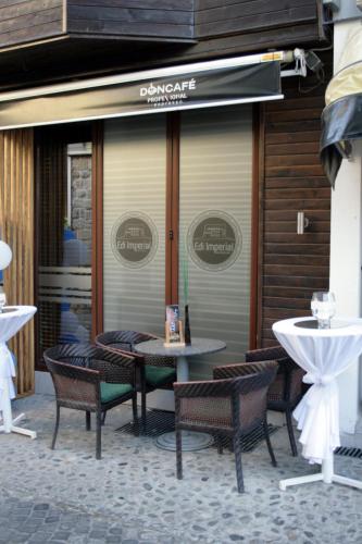 a table and chairs sitting outside of a restaurant at Saray Hotel in Prizren