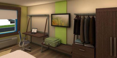 a room with a bed and a desk and a bedroom at Holiday Inn Express & Suites - King George - Dahlgren by IHG in Alden