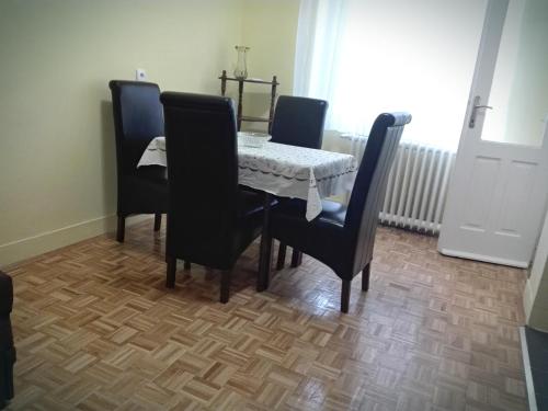 a dining room table with four chairs and a table and a table and chairsktop at Apartment Jelena in Belgrade