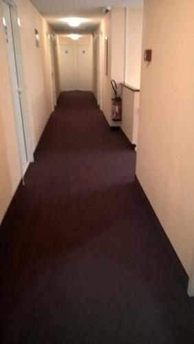 a long hallway in an office building at Hôtel Quick Palace Valence Nord in Bourg-lès-Valence